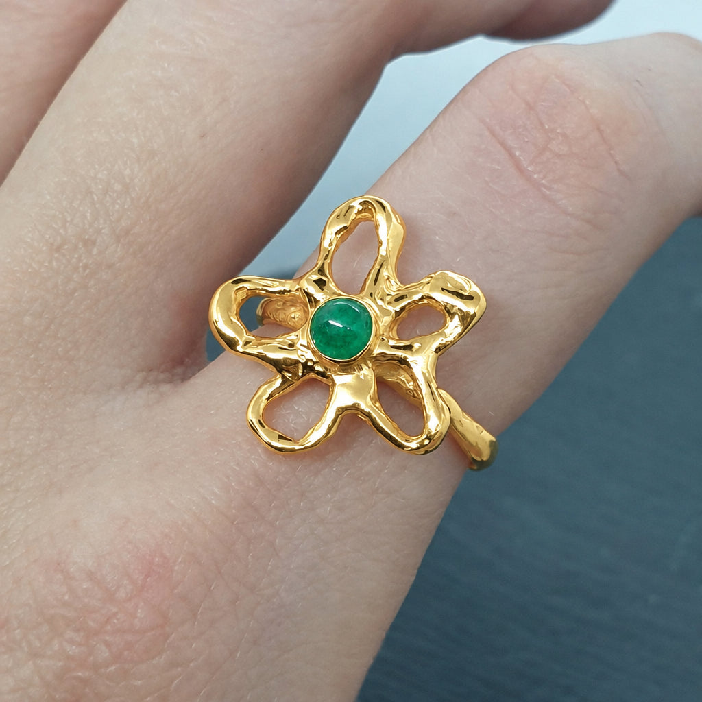 freeform flower ring made in sterling silver with a natural emerald set in the middle