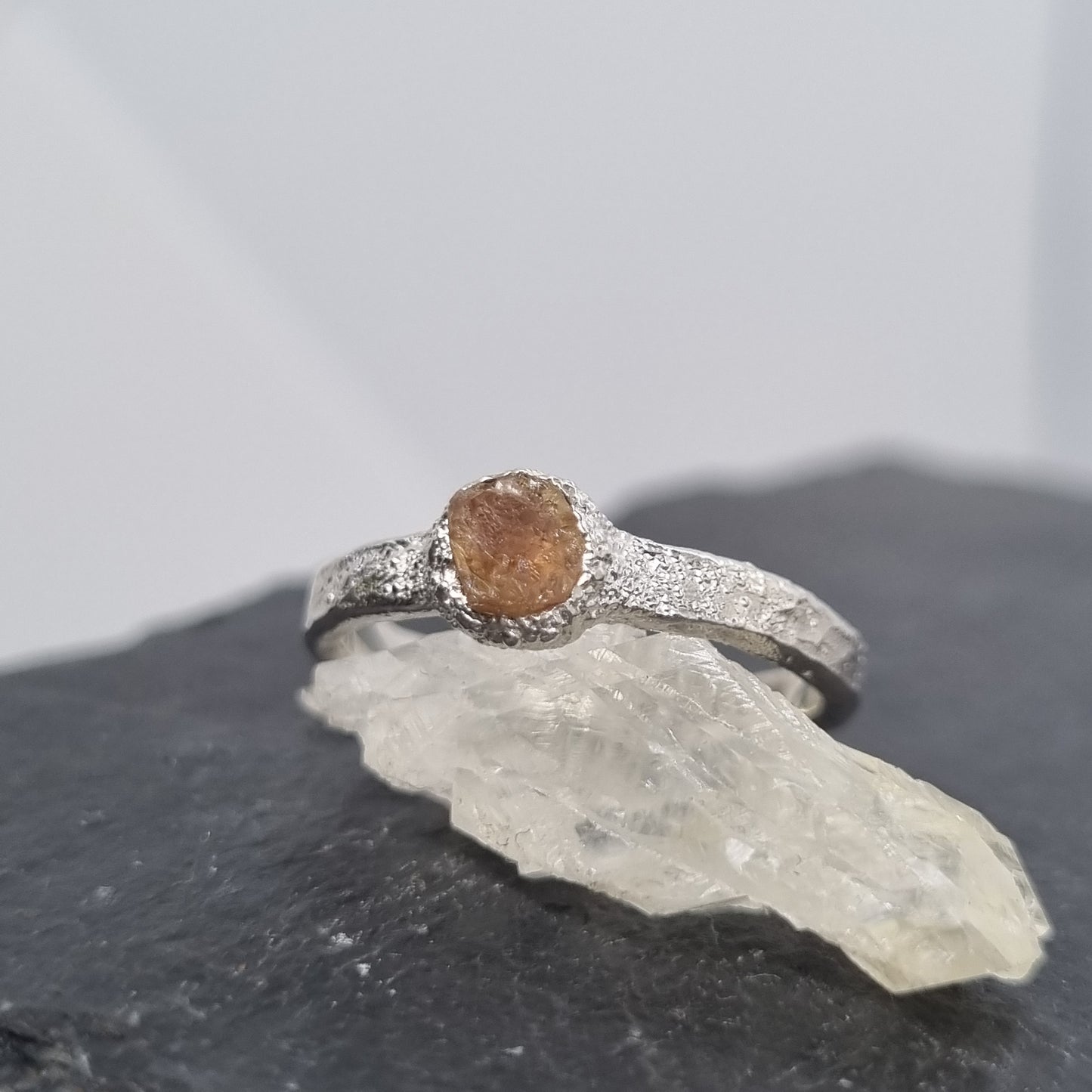 freeform textured silver ring with a rough piece of yellow topaz