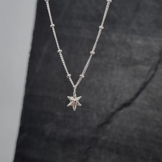 sterling silver tiny star pendant on satellite chain handmade by Jo Cooper