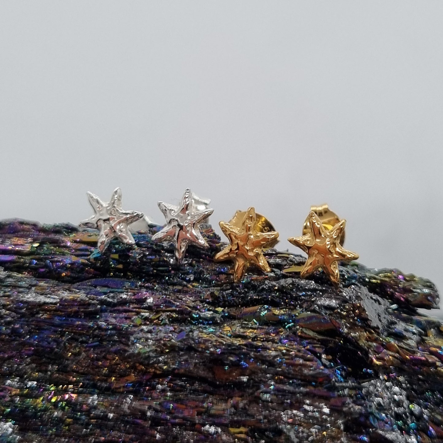 Tiny molten star sterling silver and gold vermeil stud earrings made by Jo Cooper