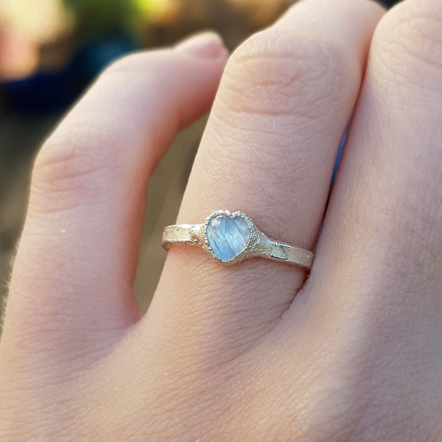 moonstone cabochon heart silver ring on finger