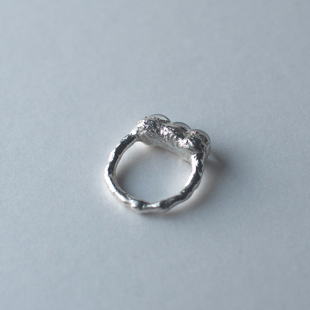 Sterling silver and glass bubble ring on a light grey background by Jo Cooper and SEICES GLASS jewellery