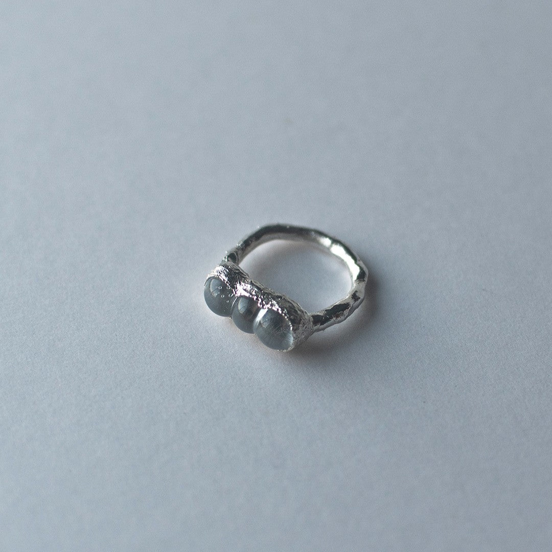 Sterling silver and glass bubble ring on a light grey background by Jo Cooper and SEICES GLASS jewellery