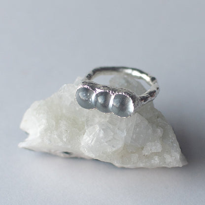 Sterling silver and glass bubble ring displayed on a crystal by Jo Cooper and SEICES GLASS jewellery