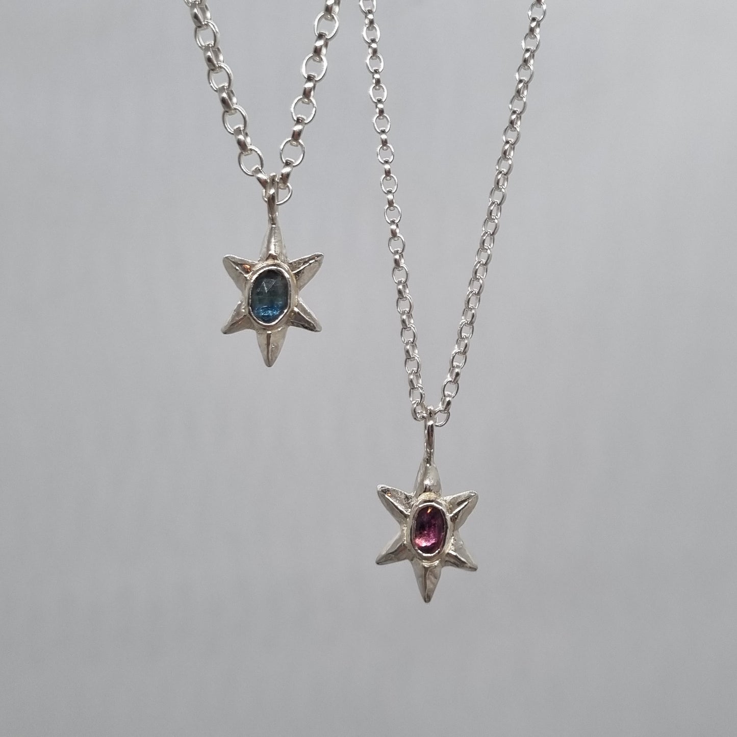 rose cut teal blue sapphire and pink Winza sapphire set in a sterling silver star necklace hand carved and handmade in recycled sterling silver by Jo Cooper Jewellery