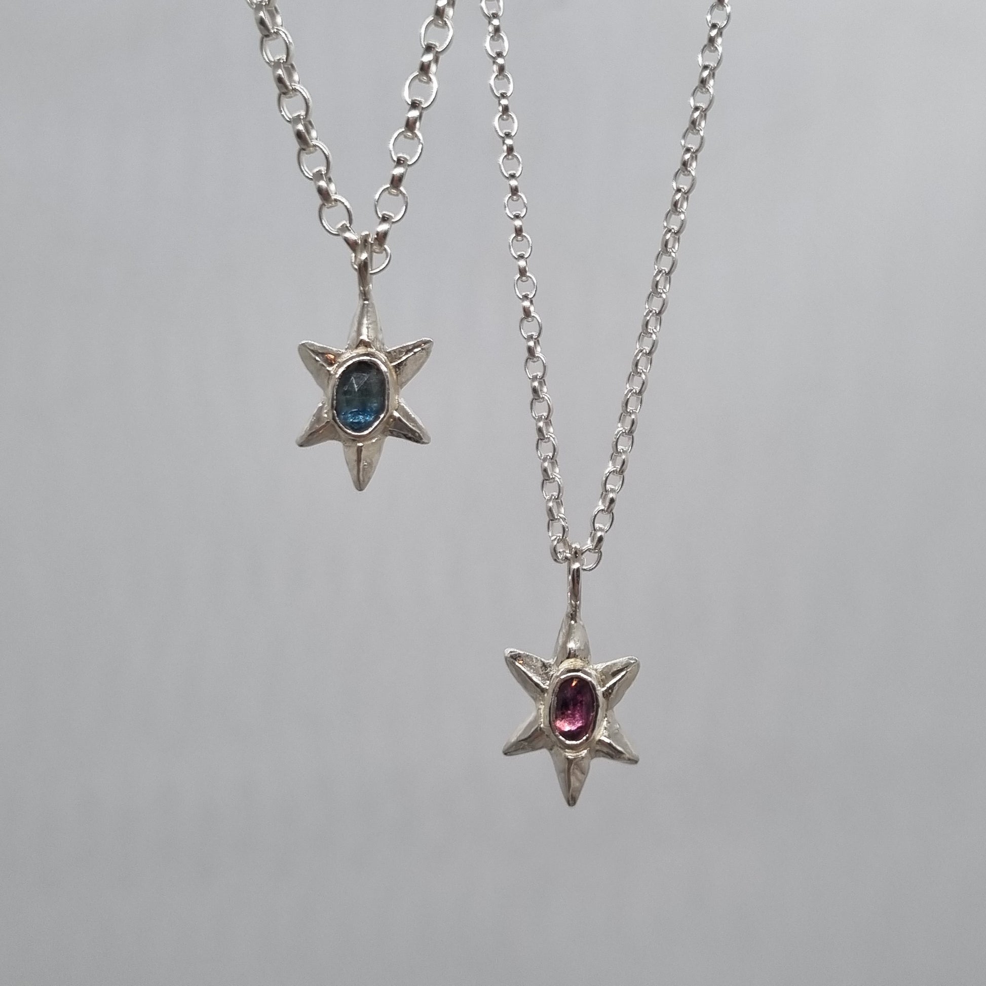 rose cut teal blue sapphire and pink Winza sapphire set in a sterling silver star necklace hand carved and handmade in recycled sterling silver by Jo Cooper Jewellery