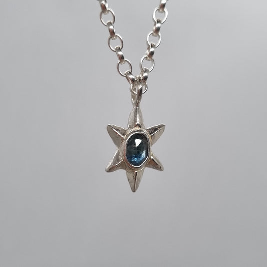 rose cut teal blue sapphire set in hand carved sterling silver faceted star pendant. Comes on a long sterling silver chain handmade by Jo Cooper Jewellery