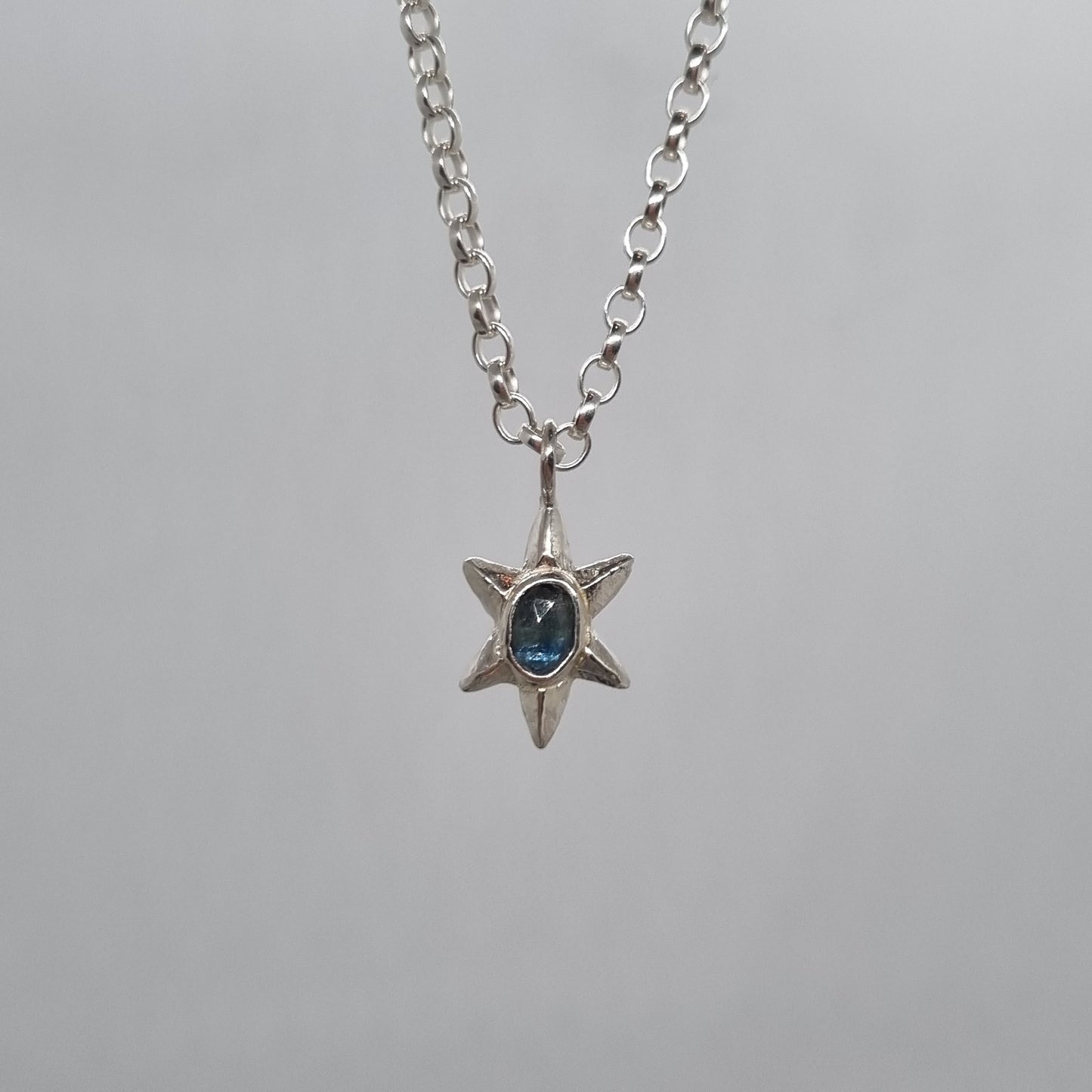 rose cut teal blue sapphire sterling silver star necklace hand carved and handmade in recycled sterling silver by Jo Cooper Jewellery