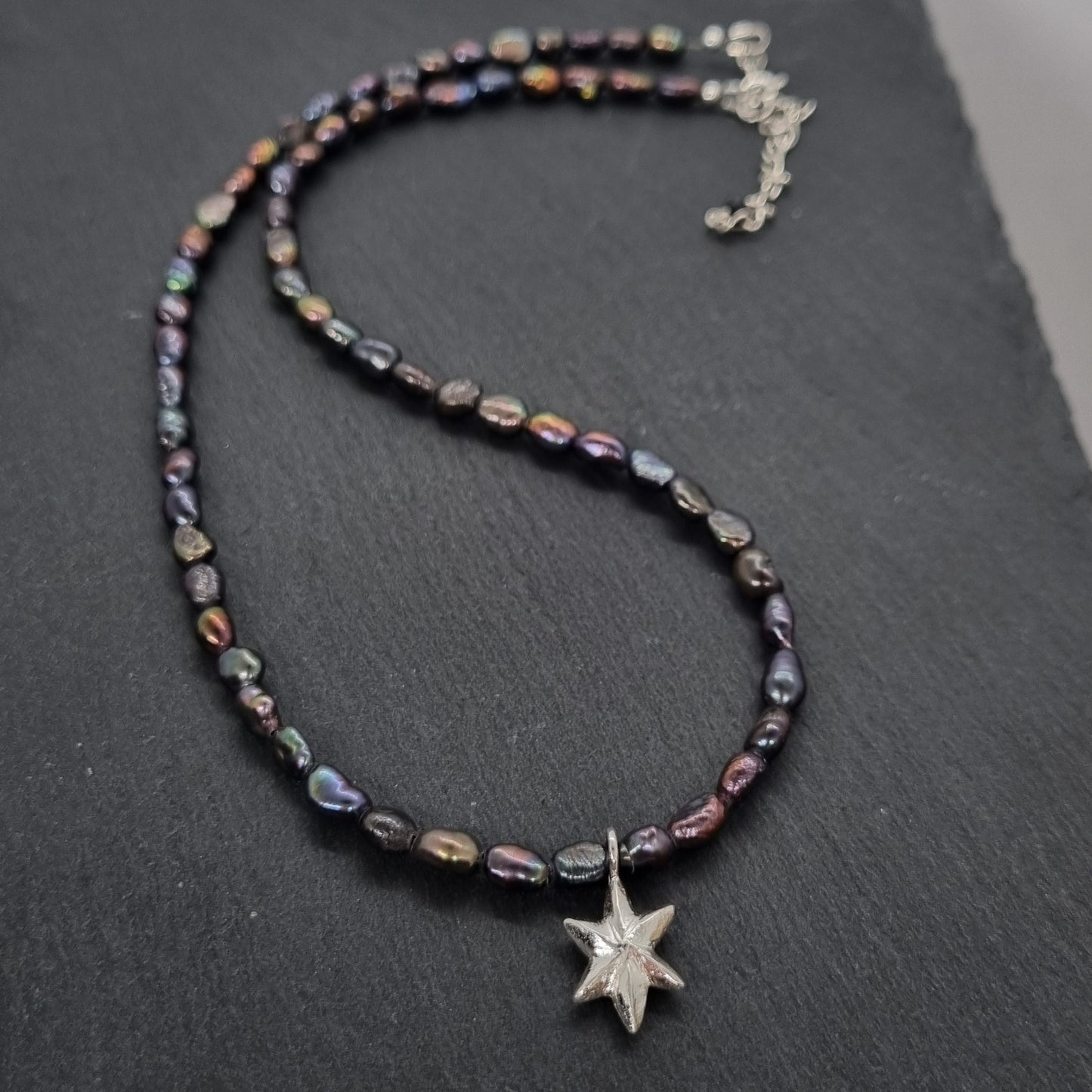 3D faceted hand carved sterling silver star on a grey peacock freshwater pearl bead necklace by Jo Cooper