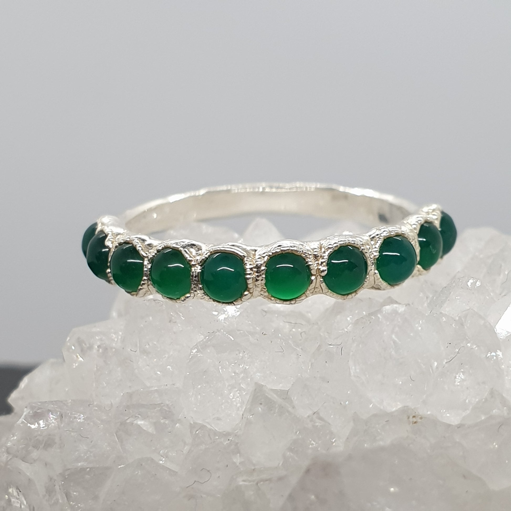 green gemstone eternity textured sterling silver ring