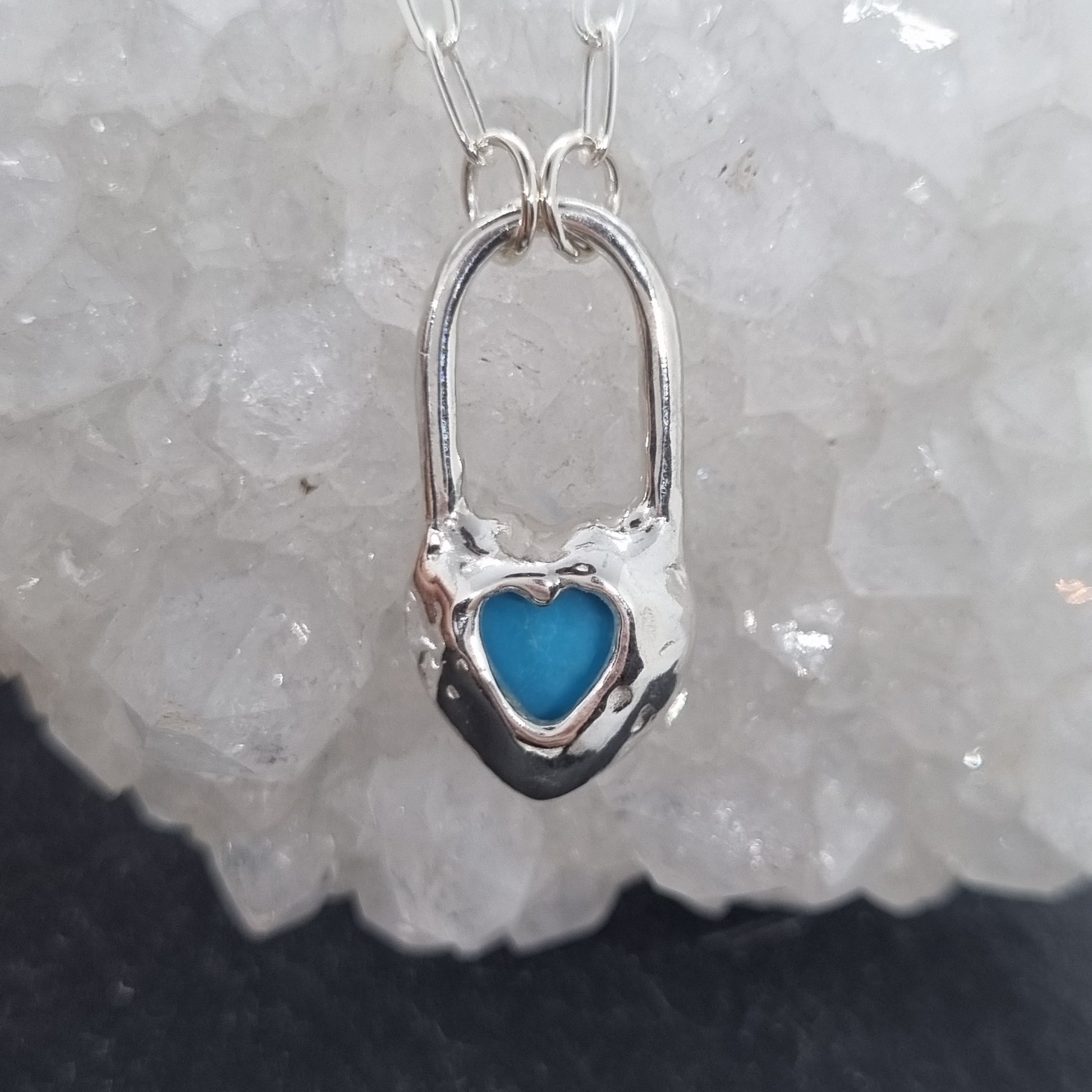 Silver heart-shaped pendant with blue turquoise gemstone