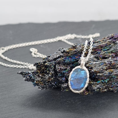 oval labradorite sterling silver pebble necklace handmade by Jo Cooper Jewellery displayed on a black crystal