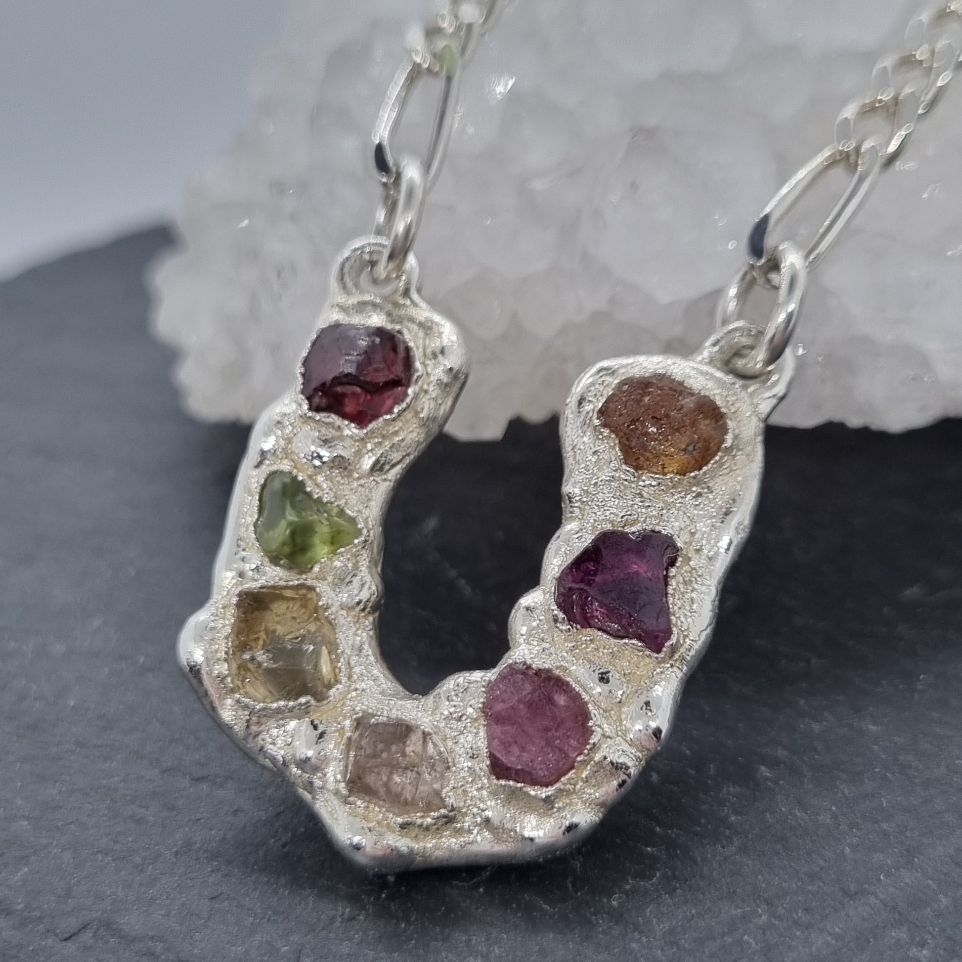 Sterling silver horseshoe pendant necklace with large multi raw natural gemstones on a figaro chain. Lunar New Year of the Horse Collection by Jo Cooper