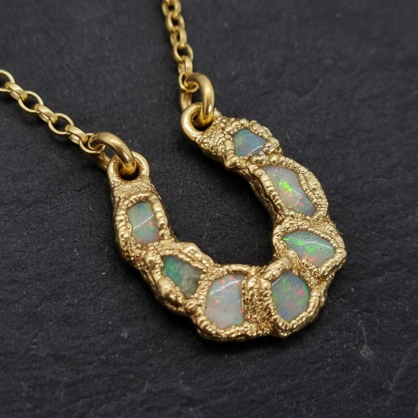 Textured gold vermeil sterling silver necklace with a lucky horseshoe pendant featuring freeform Australian opals set in it. Lunar New Year of the Horse Collection