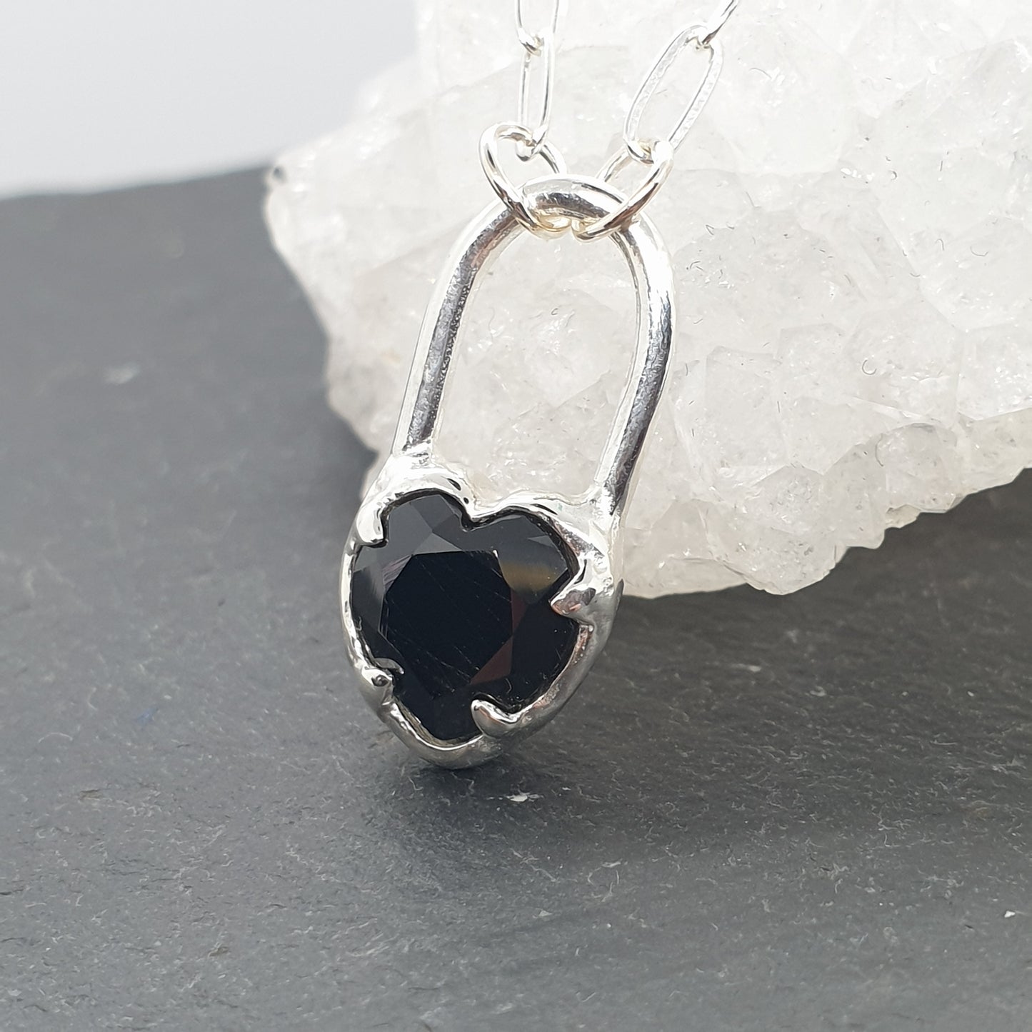 molten black spinel heart lock necklace on rectangular sterling silver chain