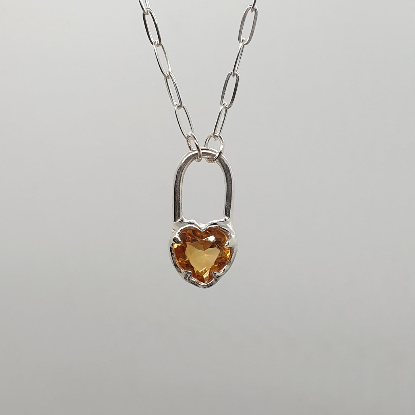 sterling silver citrine heart lock necklace on a rectangular paperclip chain