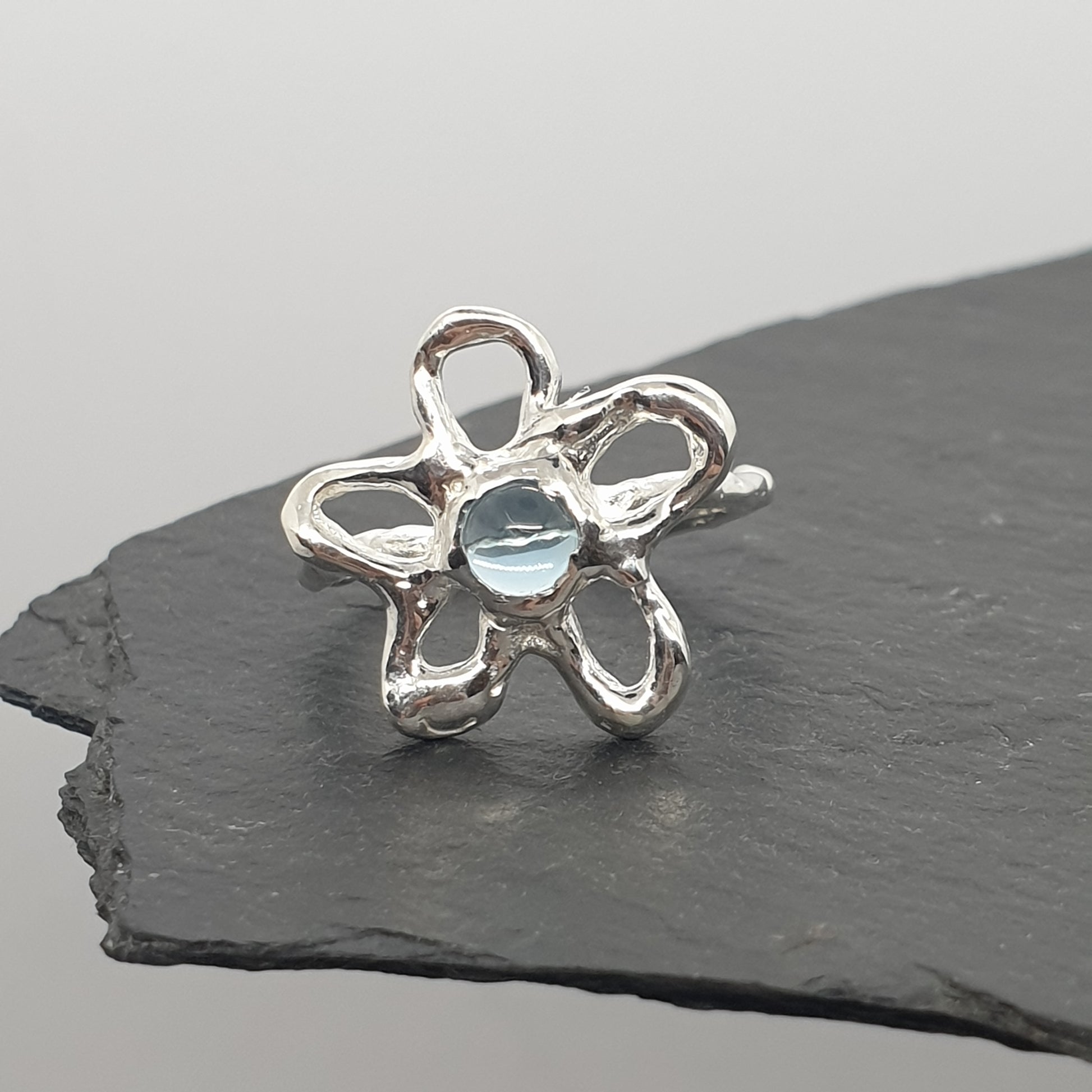 molten flower sterling silver ring with swiss blue topaz handmade by Jo Cooper