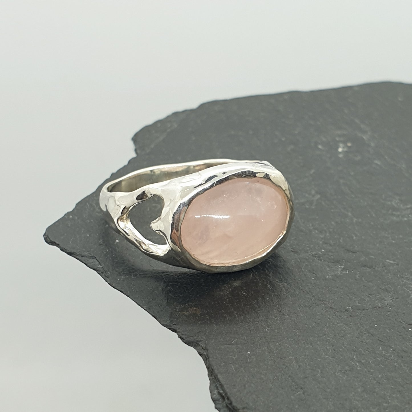 molten rose quartz sterling silver ring with cut out hearts on shoulders of ring