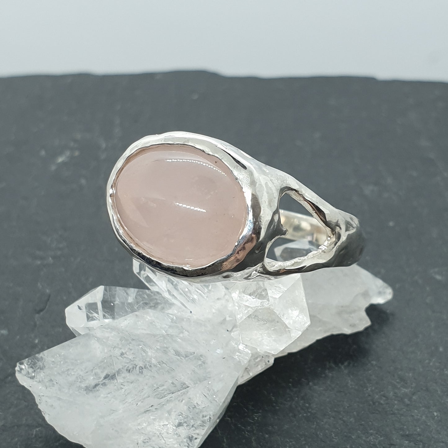 sterling silver rose quartz ring with cut out hearts on shoulders of ring