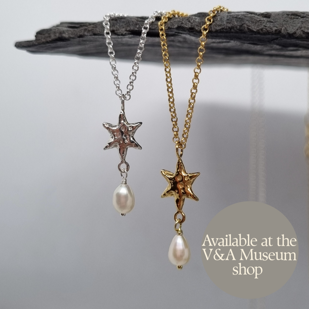 Gold plated and sterling silver star-shaped necklace with pearls made by Jo Cooper, also available at the Victoria and Albert Museum shop in London, UK.