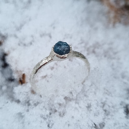 natural raw blue diamond sterling silver textured ring displayed in the snow