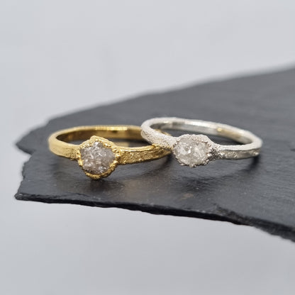 raw white diamond silver and gold rings displayed on a slate background