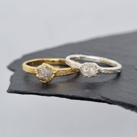 raw white diamond silver and gold rings displayed on a slate background