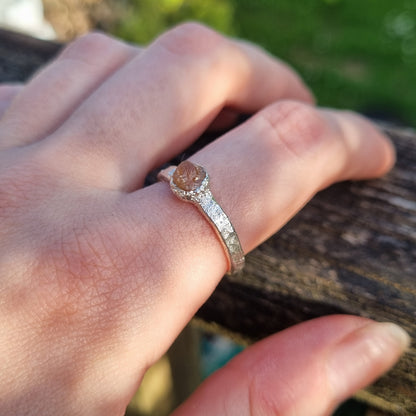 model wearing sterling silver textured ring with raw golden topaz, handmade by Jo Cooper