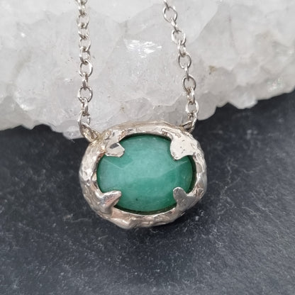 A sterling silver necklace with a rose cut emerald 