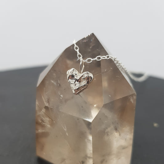 tiny molten heart necklace on crystal