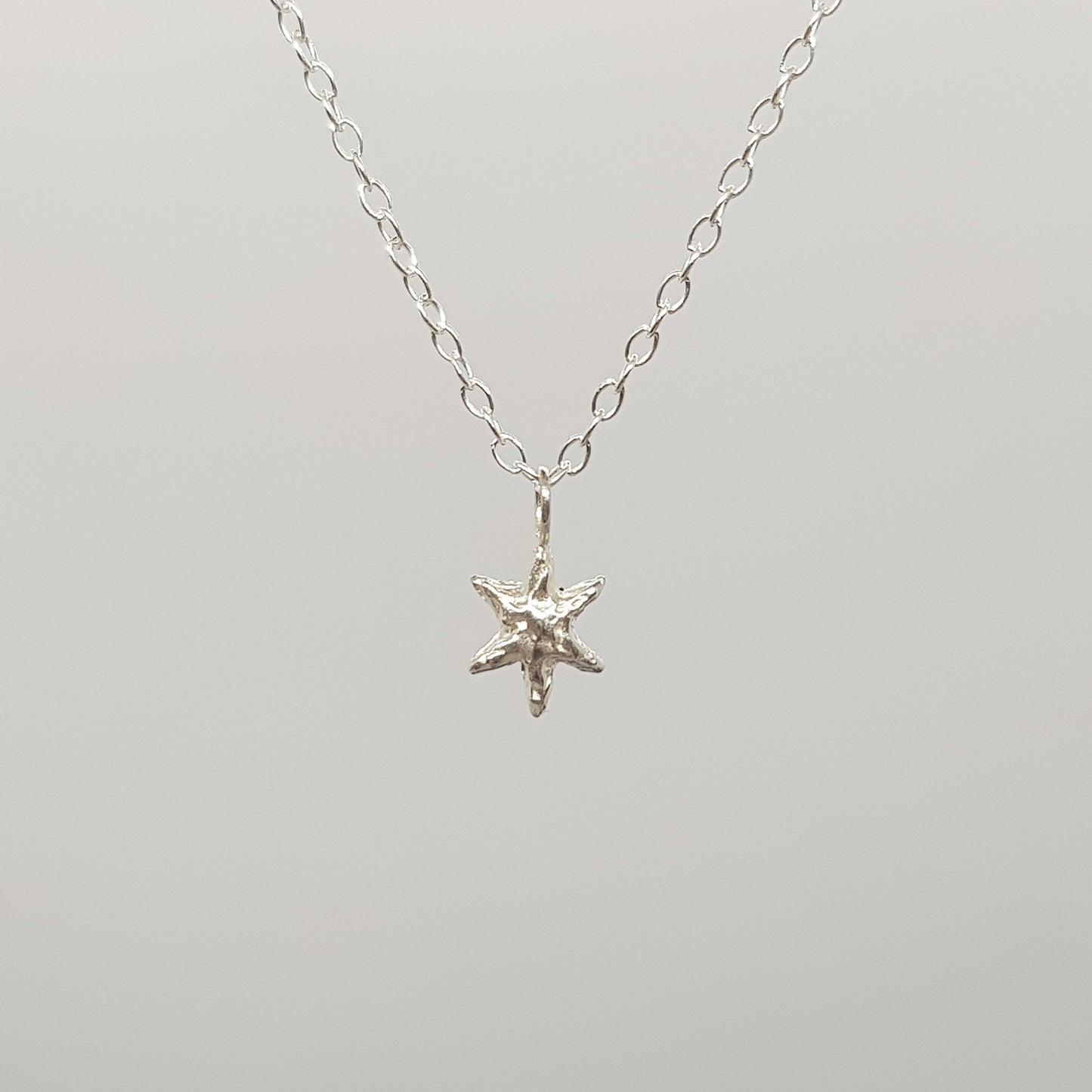 tiny molten star necklace sterling silver