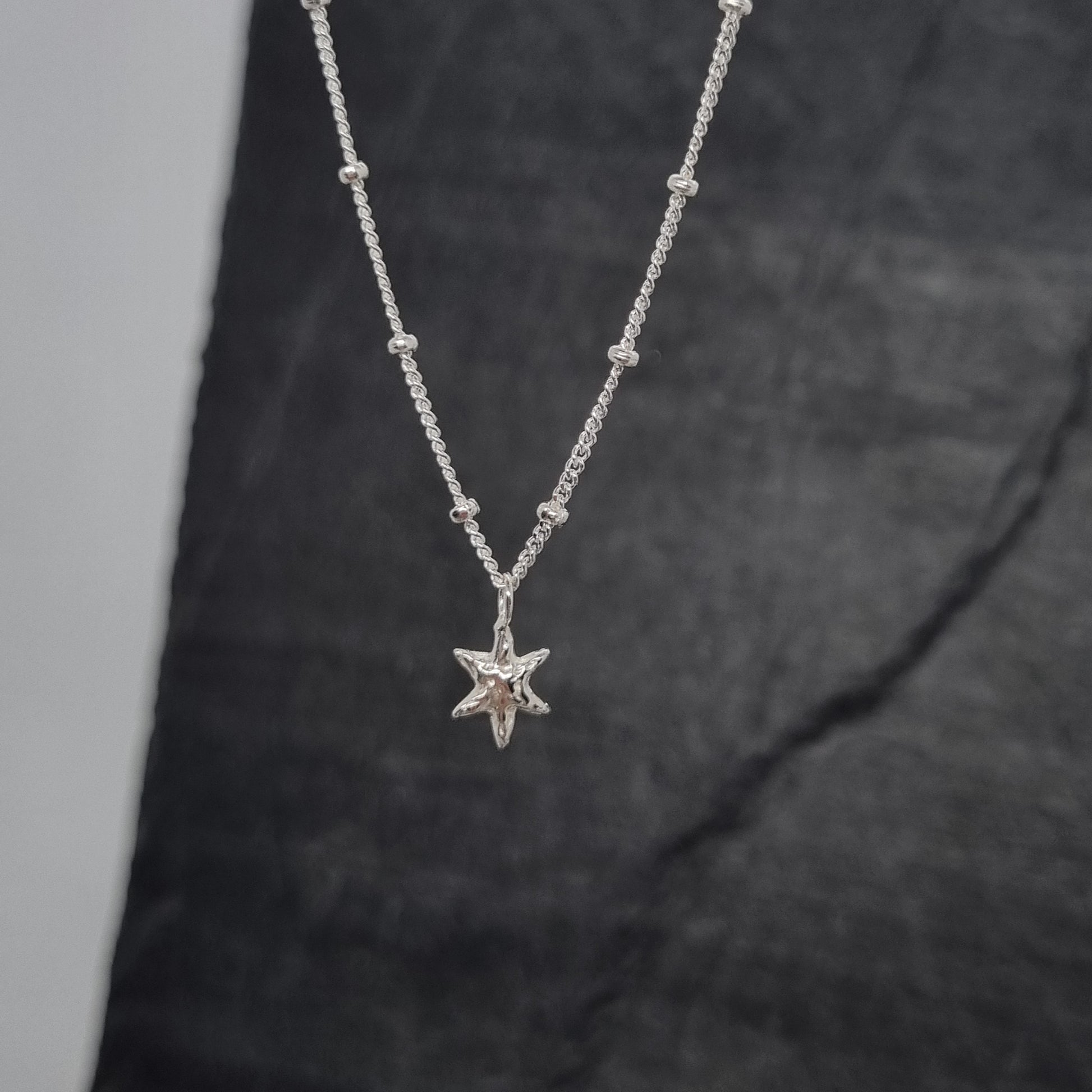 sterling silver tiny star pendant on satellite chain handmade by Jo Cooper