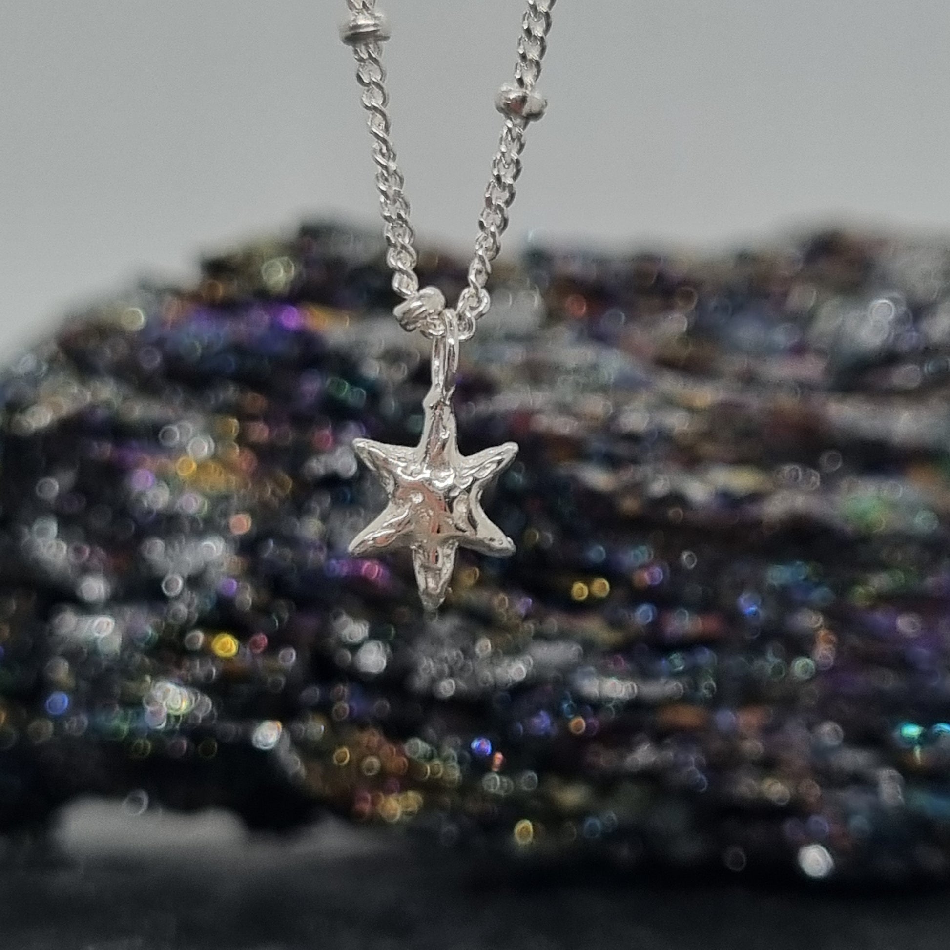 sterling silver tiny star pendant on satellite chain handmade by Jo Cooper