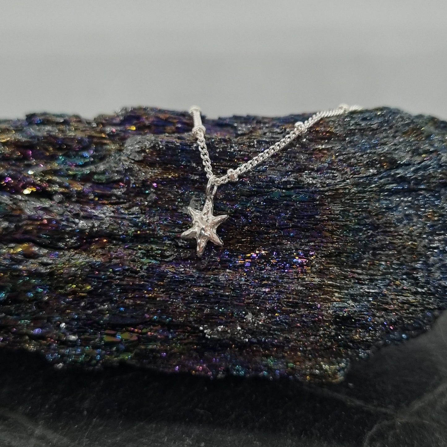 textured sterling silver tiny star pendant on satellite chain handmade by Jo Cooper