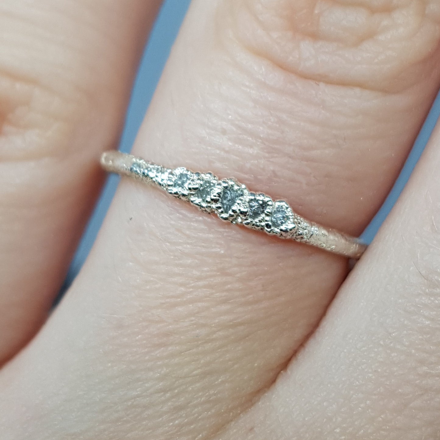 raw white diamond and silver eternity ring, handmade in the UK, worn on a woman's finger