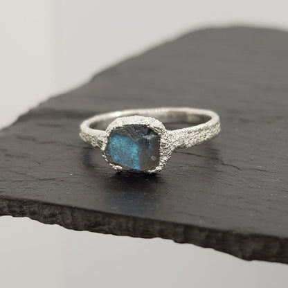 raw labradorite silver textured ring displayed on slate