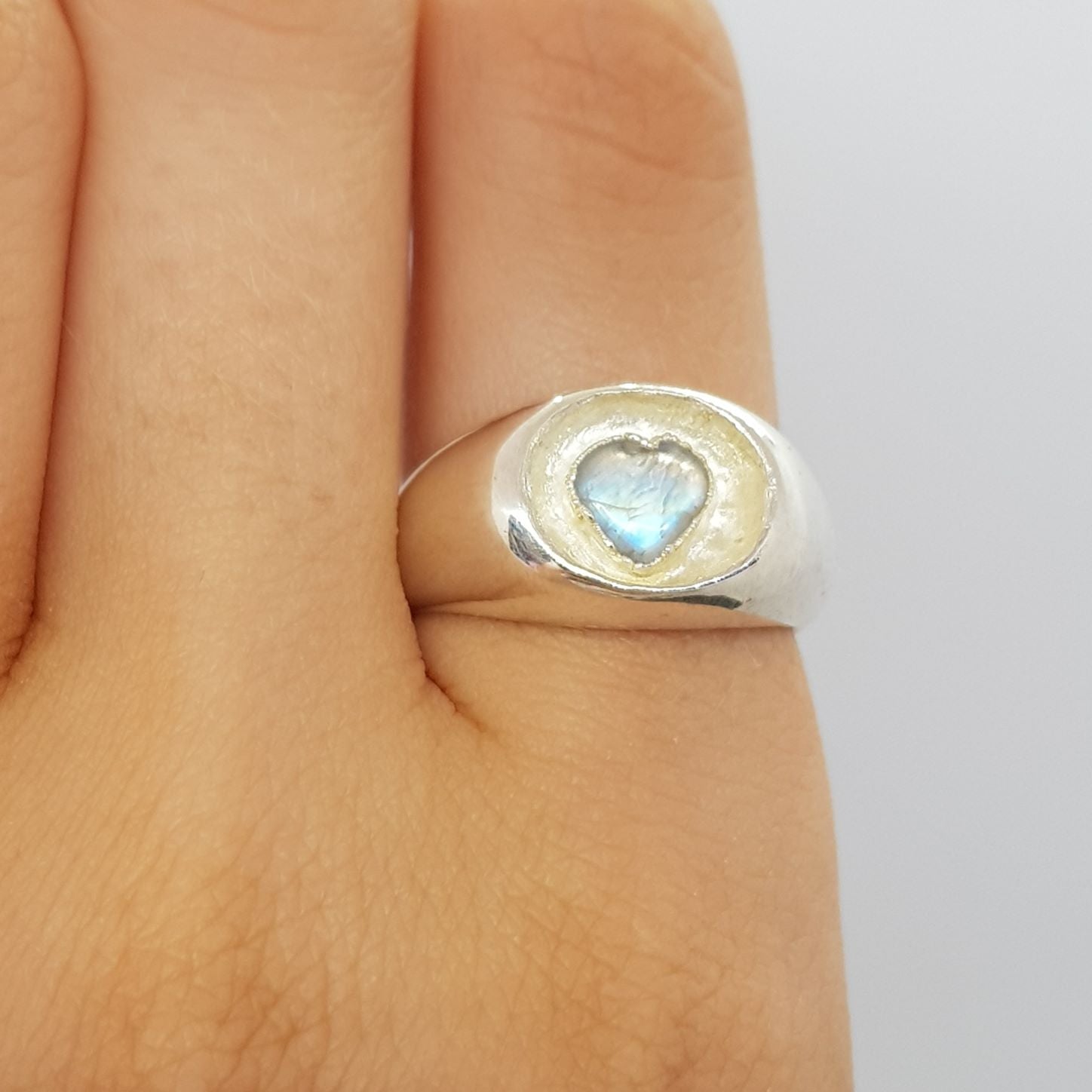 moonstone heart sunken silver signet ring on finger