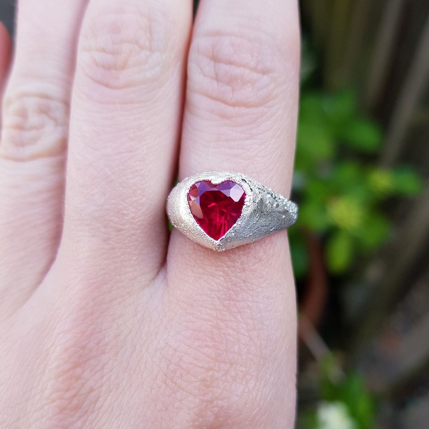 ruby heart chunky silver signet ring on finger