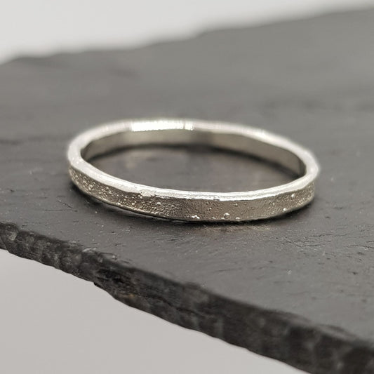 rustic raw silver ring perfect for alternative engagement or wedding ring displayed on slate