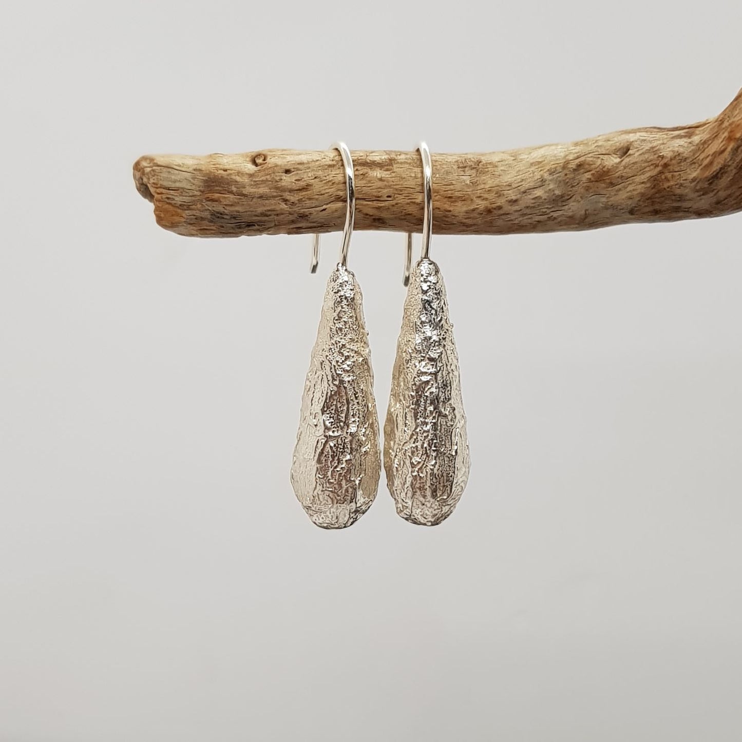 organic textured silver long drop hook earrings
