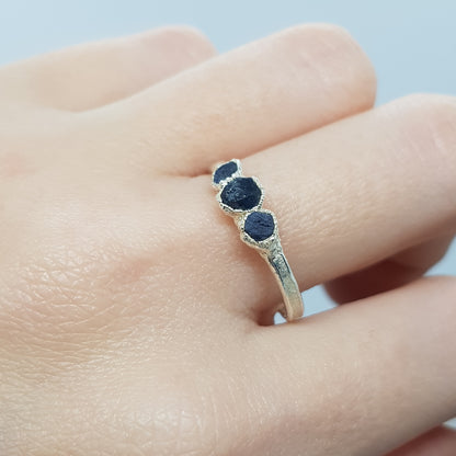 raw multi sapphire ring on finger